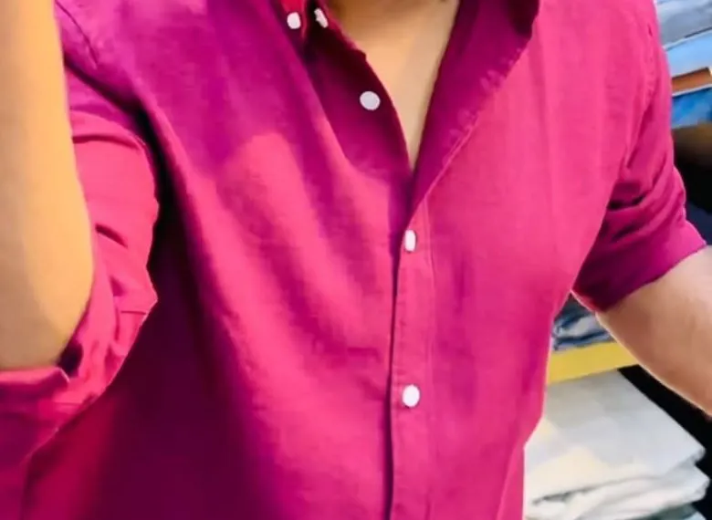 Close-up of a solid berry shirt with rolled sleeve