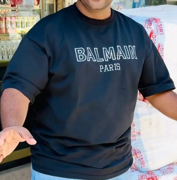 Close-up of the black oversized tee with white chest print