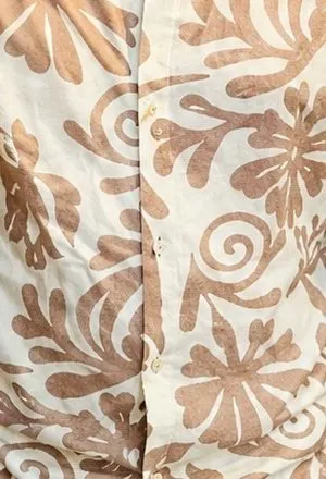 Close-up of the sand-brown floral print on cream fabric